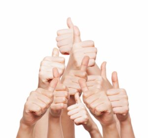 hand of business group with thumbs up